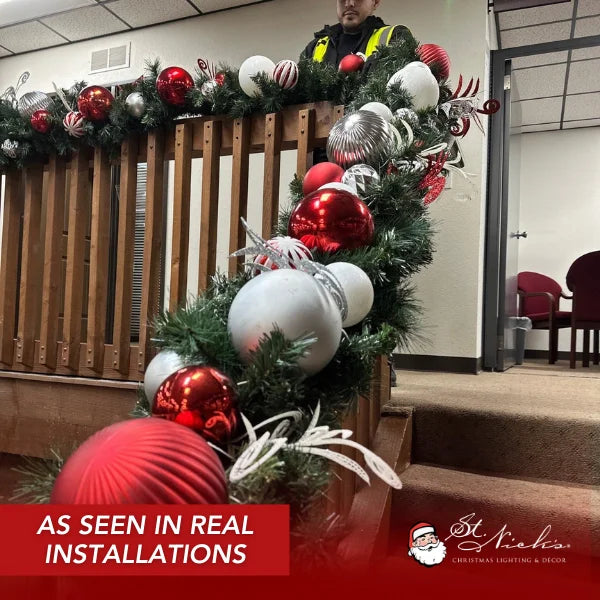 9 foot by 14 inch pre-decorated green garland with red, white, and silver ornaments and warm white LED lights